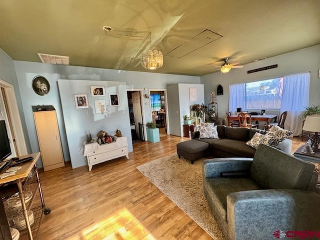 living room featuring ceiling fan and wood-type flooring