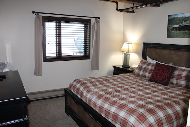 carpeted bedroom featuring a baseboard heating unit