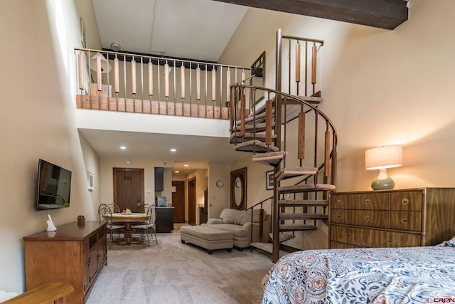 carpeted bedroom with a high ceiling