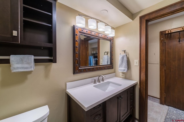 bathroom with tile patterned floors, vanity, and toilet