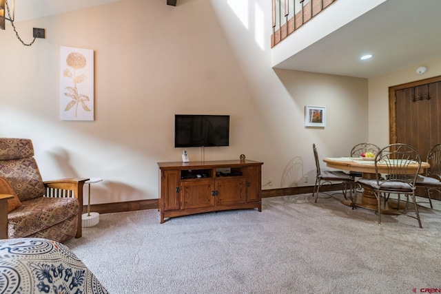 dining room with light colored carpet and lofted ceiling