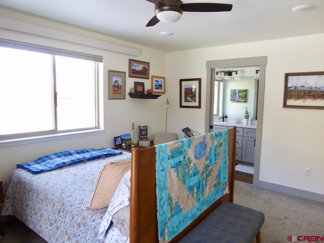 carpeted bedroom featuring ensuite bath and ceiling fan