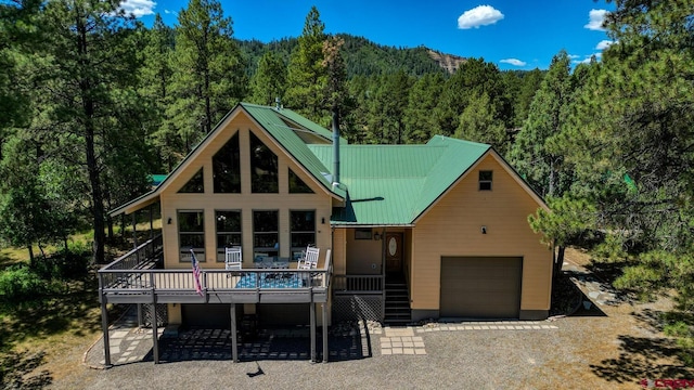 view of front facade featuring a garage and a wooden deck