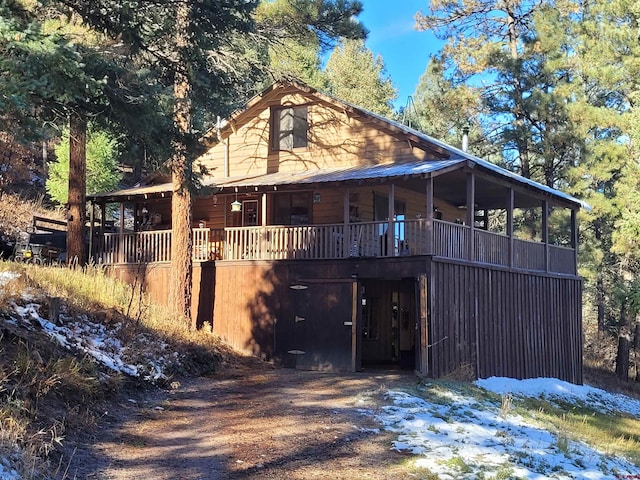 back of house featuring a sunroom