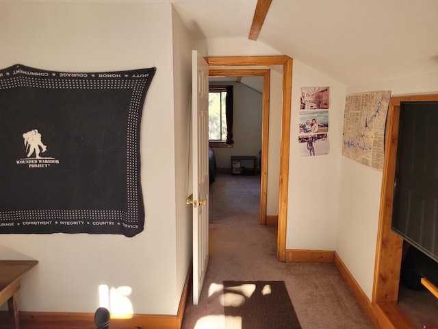 hallway featuring carpet and lofted ceiling with beams