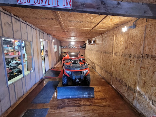 garage featuring wood walls