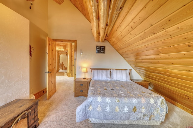 bedroom featuring vaulted ceiling with beams, wooden ceiling, and light carpet