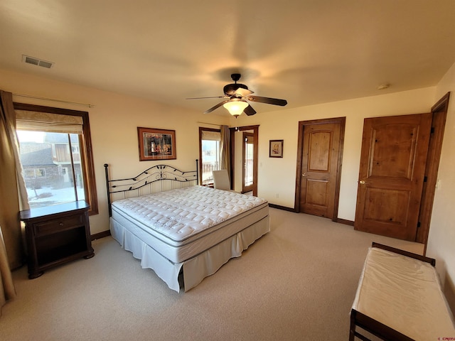 bedroom with ceiling fan and light carpet