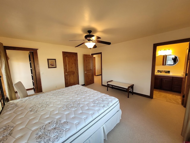 carpeted bedroom featuring connected bathroom and ceiling fan