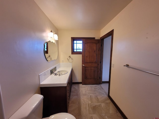 bathroom with toilet and vanity