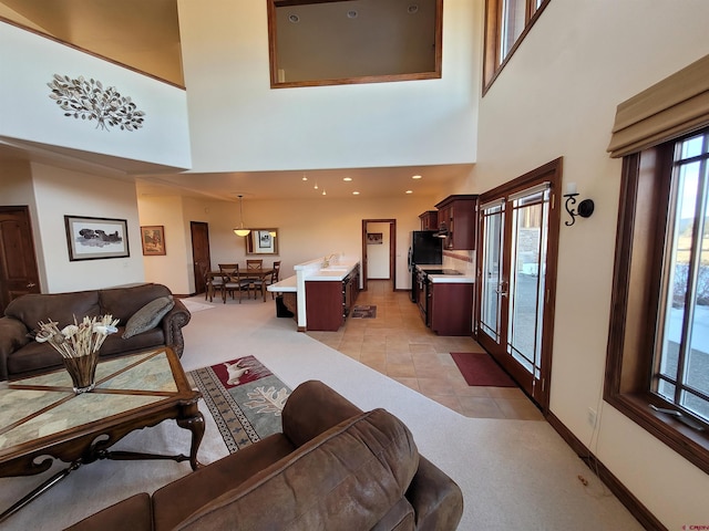 tiled living room with a towering ceiling