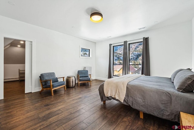 bedroom featuring dark hardwood / wood-style floors and baseboard heating