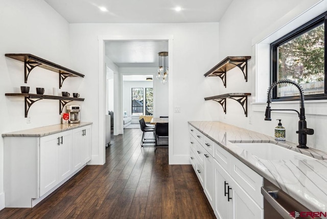 bar featuring a wealth of natural light, white cabinets, dark wood-type flooring, and light stone counters