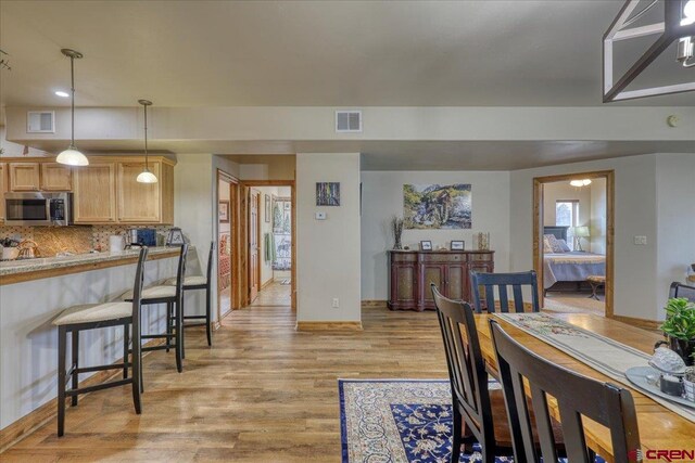 dining area with light hardwood / wood-style floors