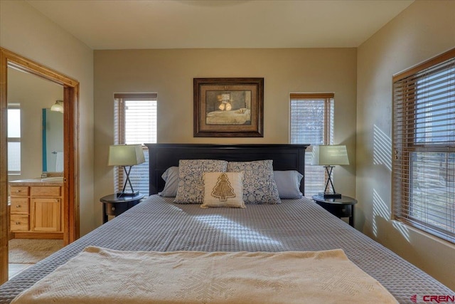 carpeted bedroom with ensuite bathroom