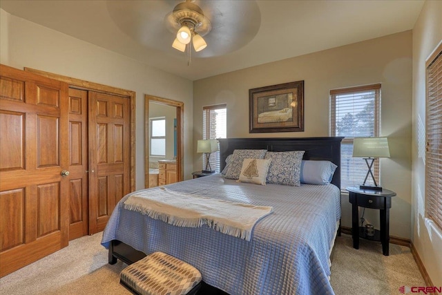 carpeted bedroom with ceiling fan and a closet