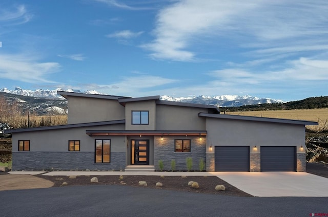 view of front of house with a mountain view and a garage