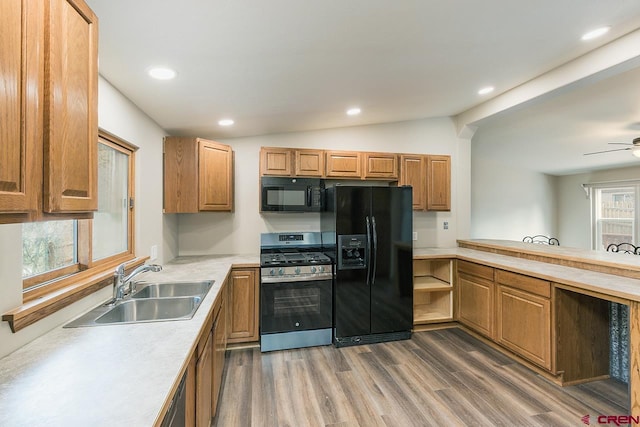 kitchen with ceiling fan, sink, dark hardwood / wood-style flooring, lofted ceiling, and black appliances