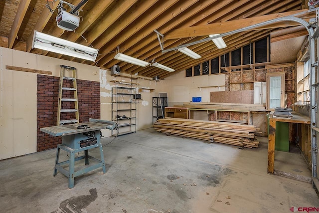 garage with a workshop area and a garage door opener