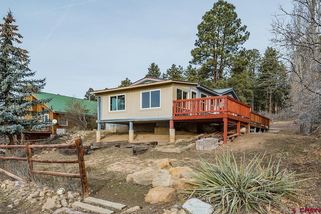 rear view of property featuring a wooden deck