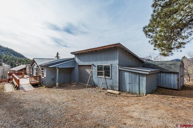 back of house with a deck