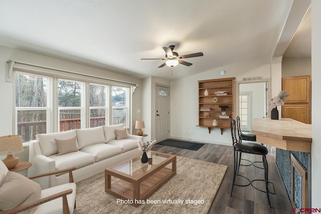 living room featuring ceiling fan, dark hardwood / wood-style flooring, and lofted ceiling