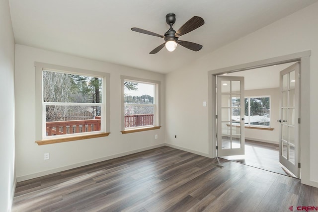 spare room with ceiling fan, french doors, dark wood-type flooring, and vaulted ceiling