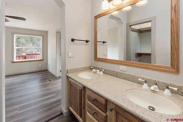 bathroom featuring wood-type flooring, vanity, and ceiling fan