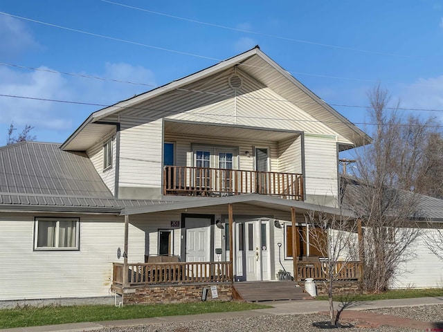 view of front facade featuring covered porch and a balcony