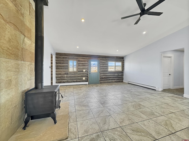 living area with recessed lighting, a ceiling fan, baseboards, baseboard heating, and a wood stove