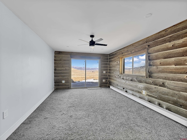 unfurnished room featuring a ceiling fan, carpet, log walls, and baseboards