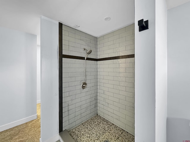 full bath with a shower stall and baseboards