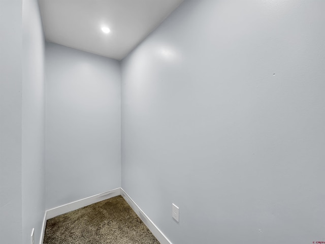 unfurnished room with carpet floors and baseboards