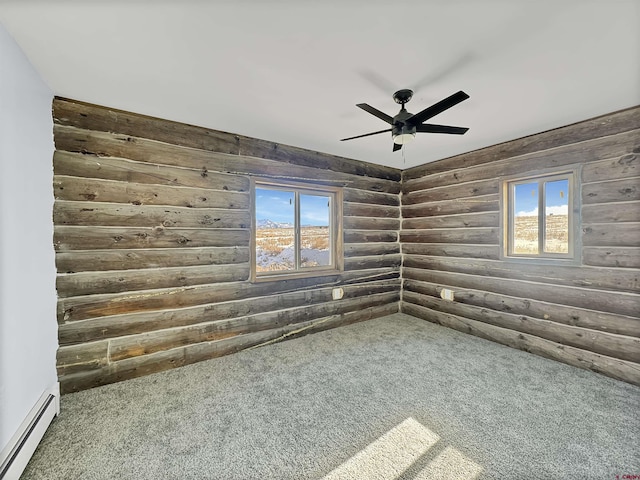 carpeted empty room with ceiling fan, baseboard heating, and rustic walls