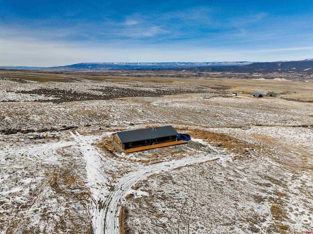 snowy aerial view with a mountain view