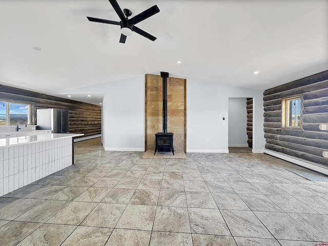 unfurnished living room with baseboards, vaulted ceiling, a ceiling fan, and recessed lighting