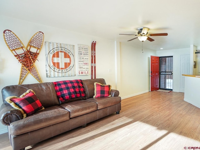 living room with ceiling fan and light wood-type flooring