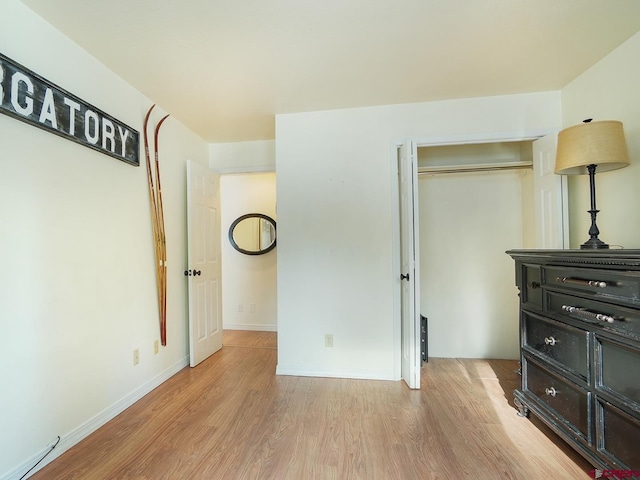 bedroom featuring a closet and light hardwood / wood-style floors