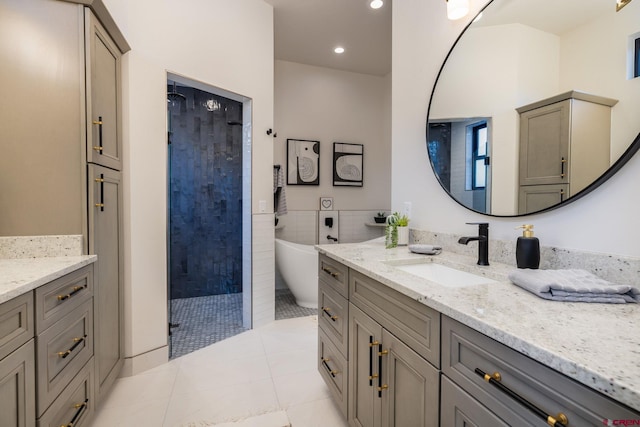 bathroom featuring tile patterned floors, vanity, and independent shower and bath