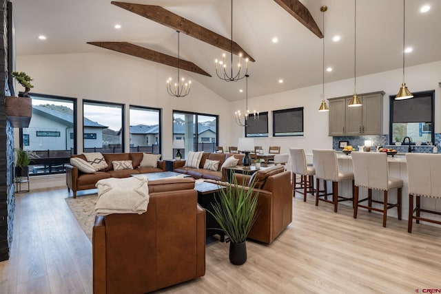 living room featuring beamed ceiling, an inviting chandelier, high vaulted ceiling, and light hardwood / wood-style flooring