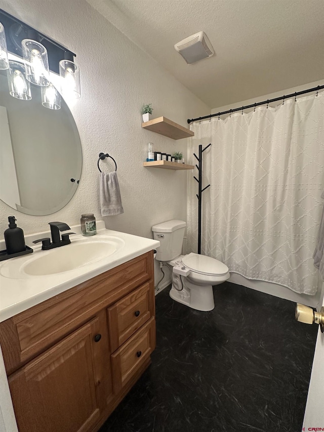 bathroom featuring walk in shower, vanity, a textured ceiling, and toilet