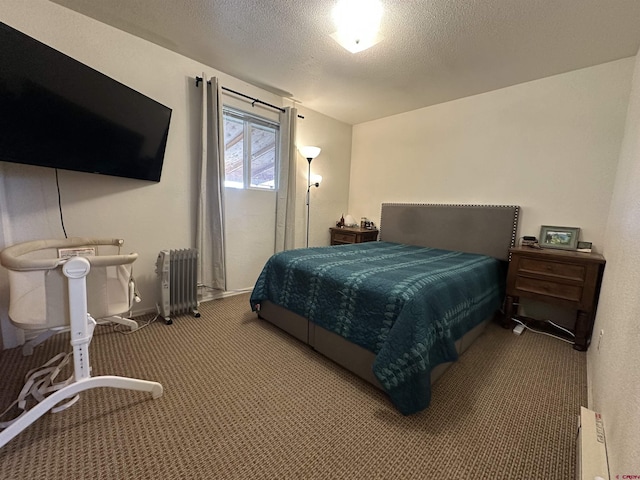 carpeted bedroom featuring radiator heating unit and a textured ceiling