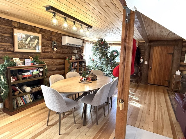 dining room featuring a wall mounted air conditioner, light hardwood / wood-style floors, wood ceiling, and ornate columns