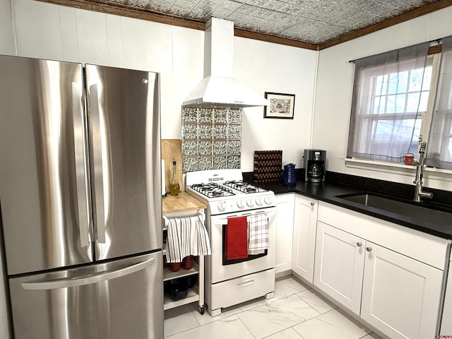 kitchen featuring sink, stainless steel fridge, range hood, white cabinetry, and white range with gas cooktop