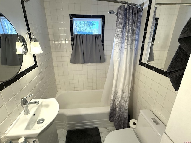 full bathroom with sink, tile patterned flooring, toilet, shower / bath combo with shower curtain, and tile walls