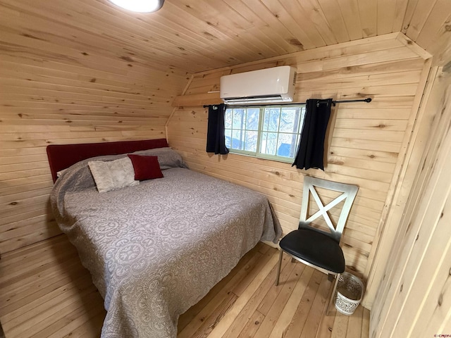 bedroom with wood walls, wooden ceiling, light hardwood / wood-style flooring, and a wall mounted AC