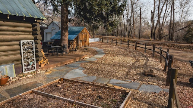 view of yard featuring an outdoor structure and a wooden deck