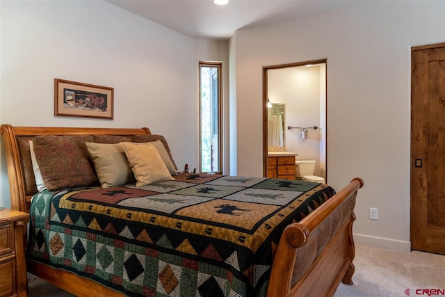 carpeted bedroom featuring ensuite bathroom