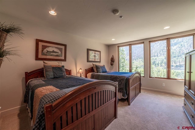 carpeted bedroom with multiple windows