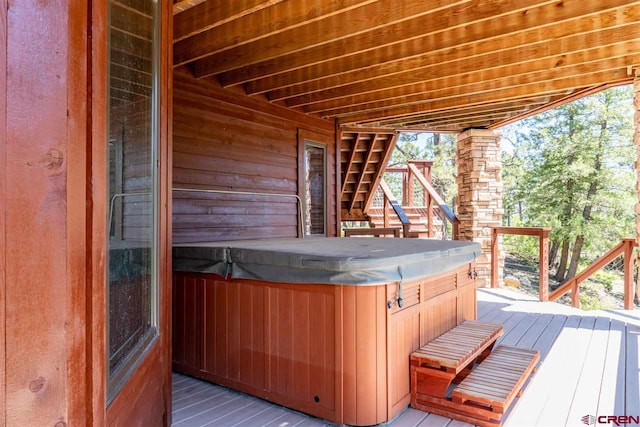 wooden deck featuring a hot tub